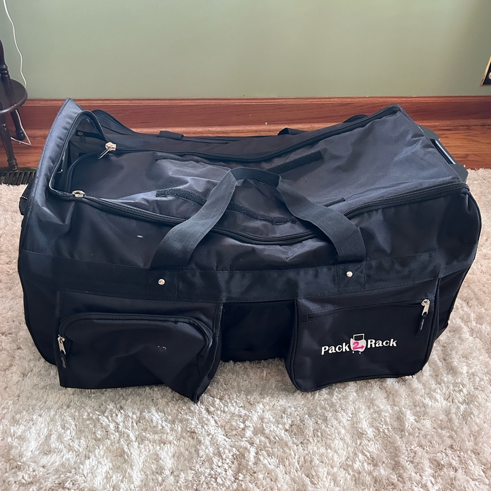 Rolling dance bag with a foldable garment rack.